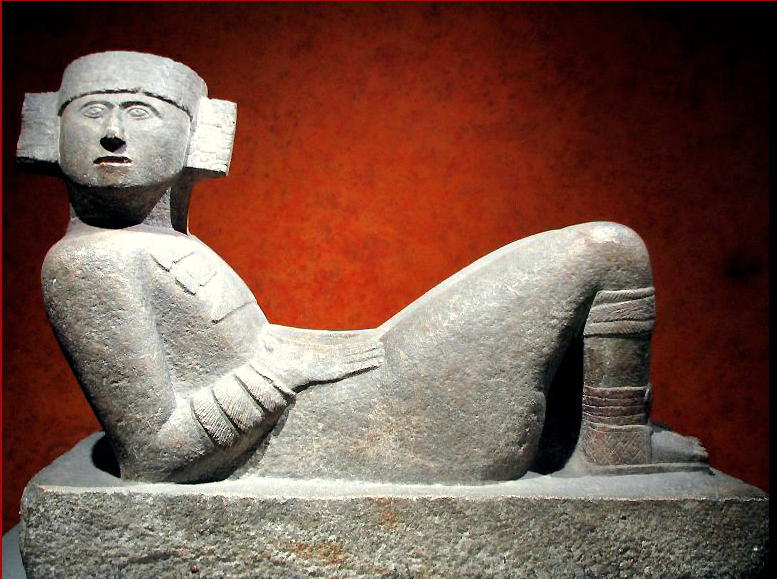 A pre-Columbian Chac Mool figure from what is now Mexico. Henry Moore saw pictures of these figures early in his career and they profoundly influenced the development of his work, both intellectually and practically. As he said: "There are three fundamental poses of the human figure. One is standing, the other is seated, and the third is lying down. Now if you like to carve the human figure in stanone, as I do, the standing pose is no good ... the figure will break off at the ankles ... the early Greeks solved this problem by draping the figure and covering the ankles .... but with either the seated or the reclining figure one does't have this worry".